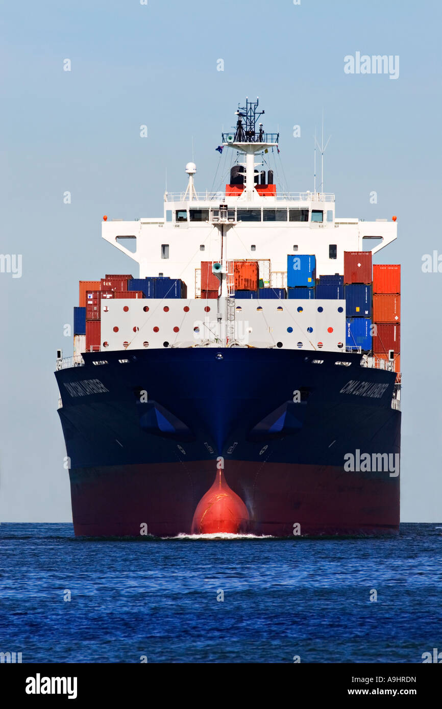 Shipping Industry / Shipping Containers stacked on the deck of a Container Ship. Stock Photo