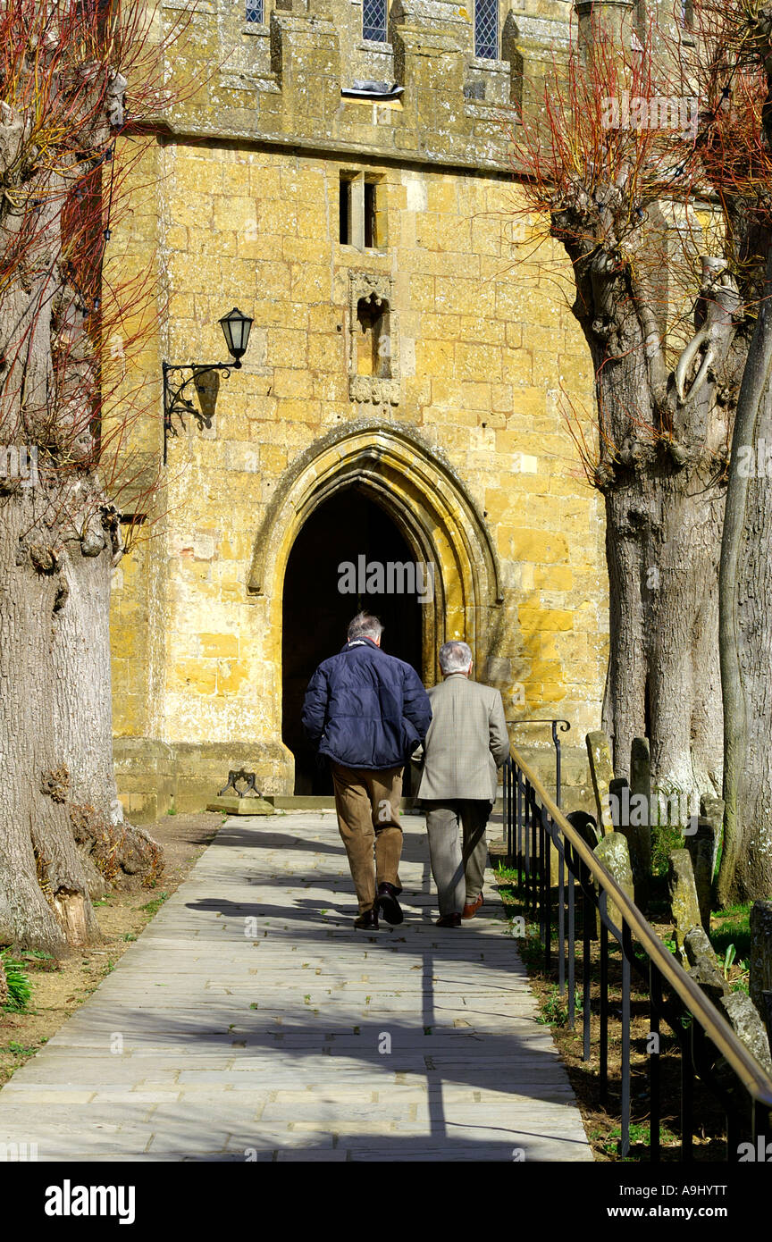 Two pensioners entering church Stock Photo