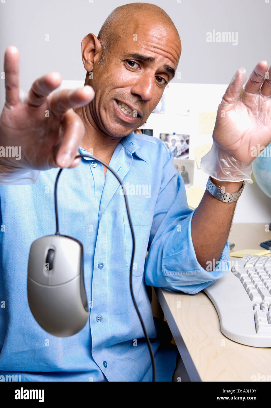 middle-aged-african-businessman-holding-computer-mouse-A9J10Y.jpg