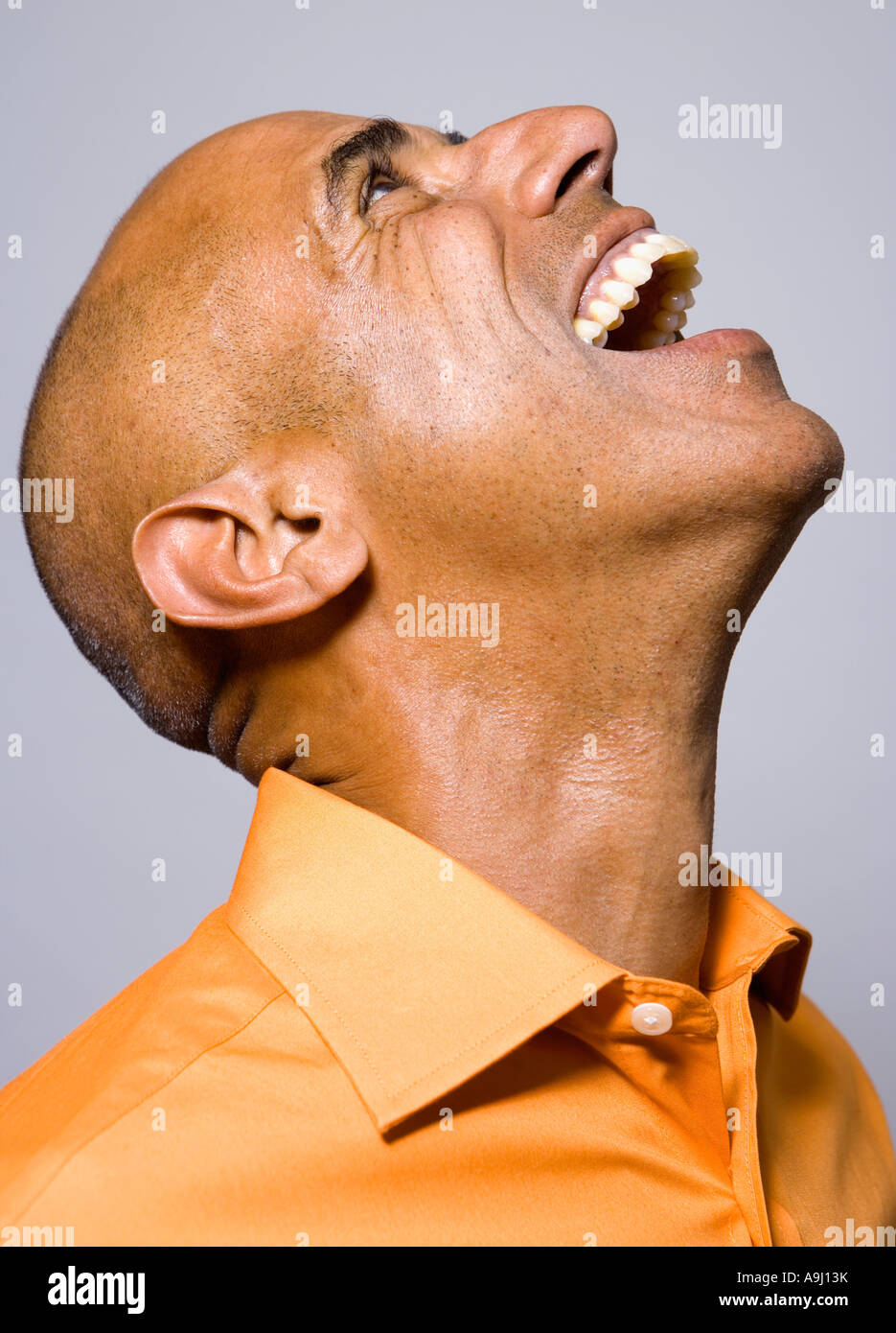 Portrait of African man laughing and looking up Stock Photo