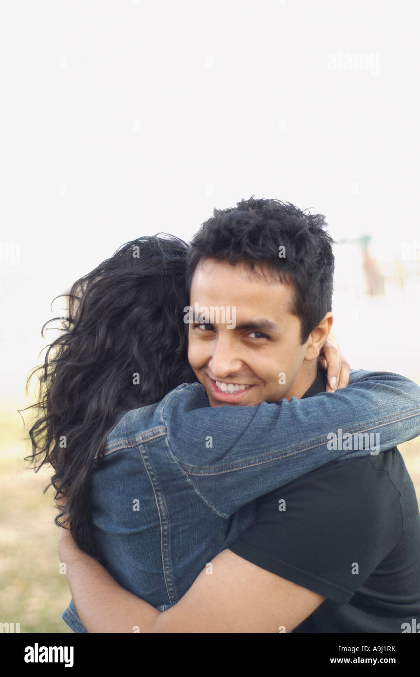Portrait of couple hugging outdoors Stock Photo - Alamy