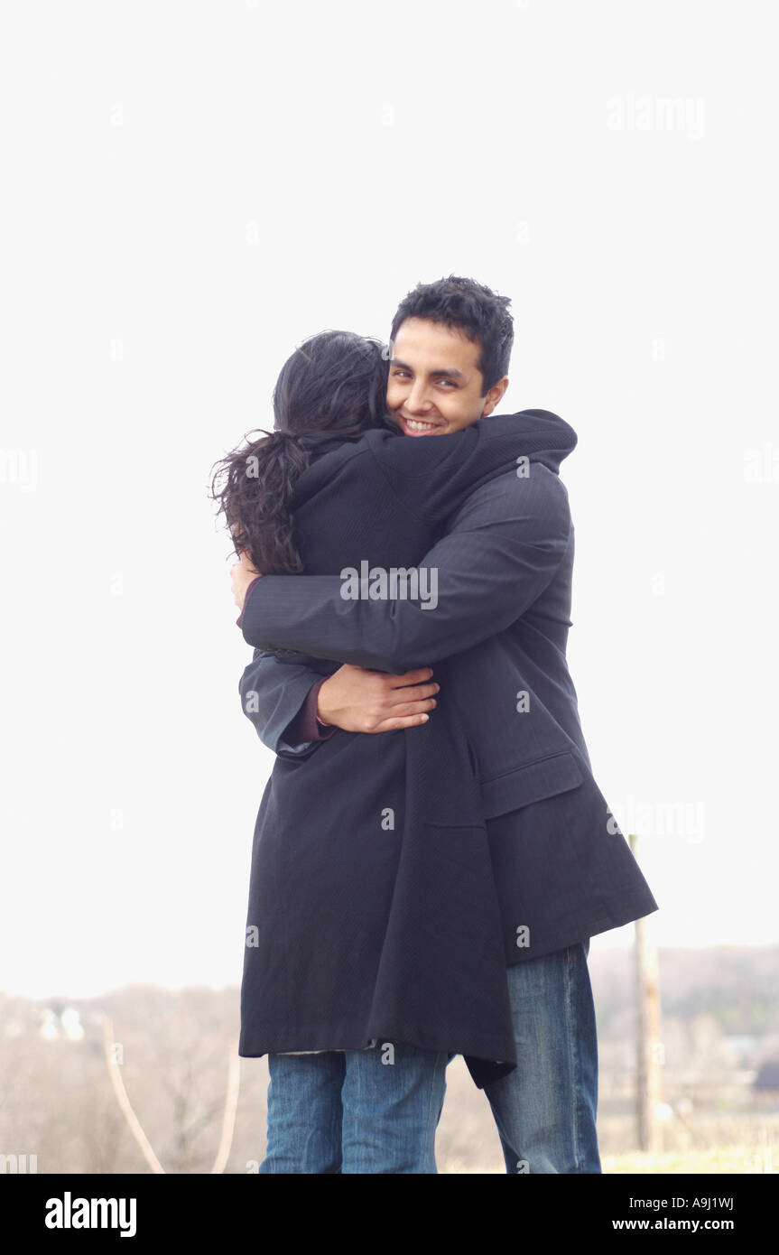Portrait of couple hugging outdoors Stock Photo - Alamy