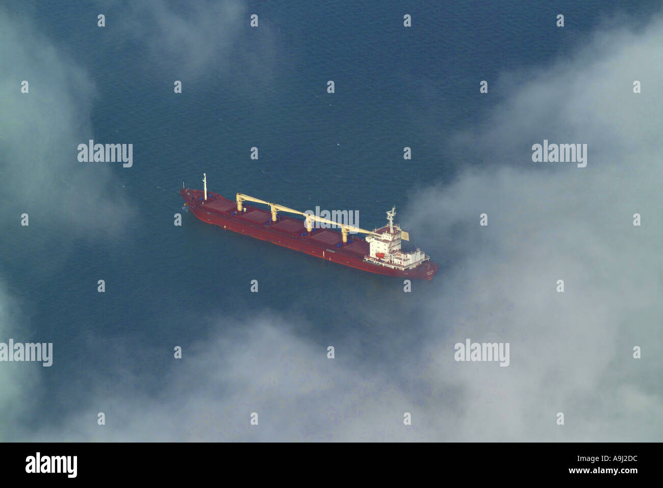 Aerial view of an oil tanker type ship at sea in the English Channel, seen through the clouds Stock Photo