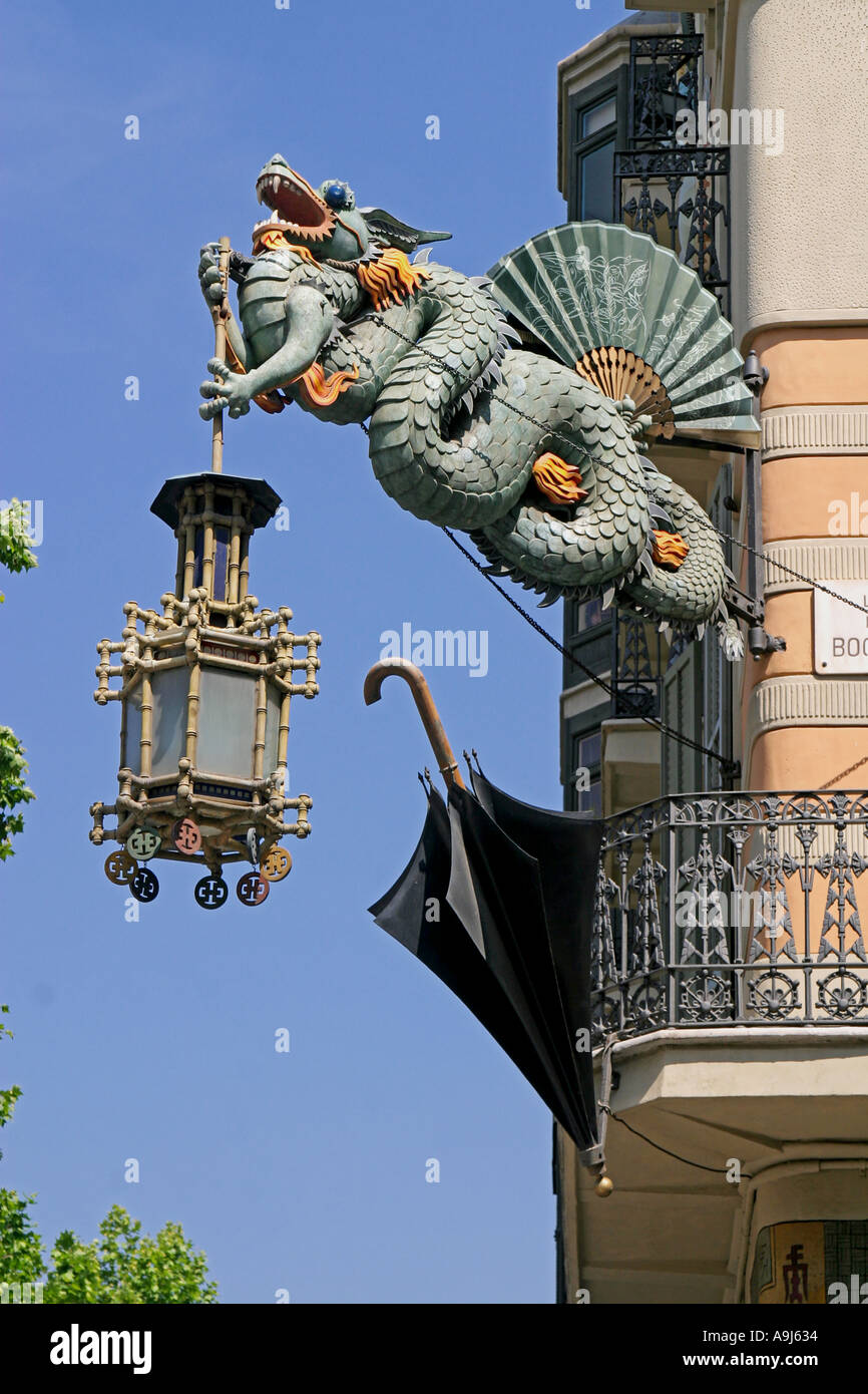 Casa Bruno Cuadros, Ramblas Art Deco dragon with laterne umbrella shop hanging on a house fassade , Barcelona , spain Stock Photo
