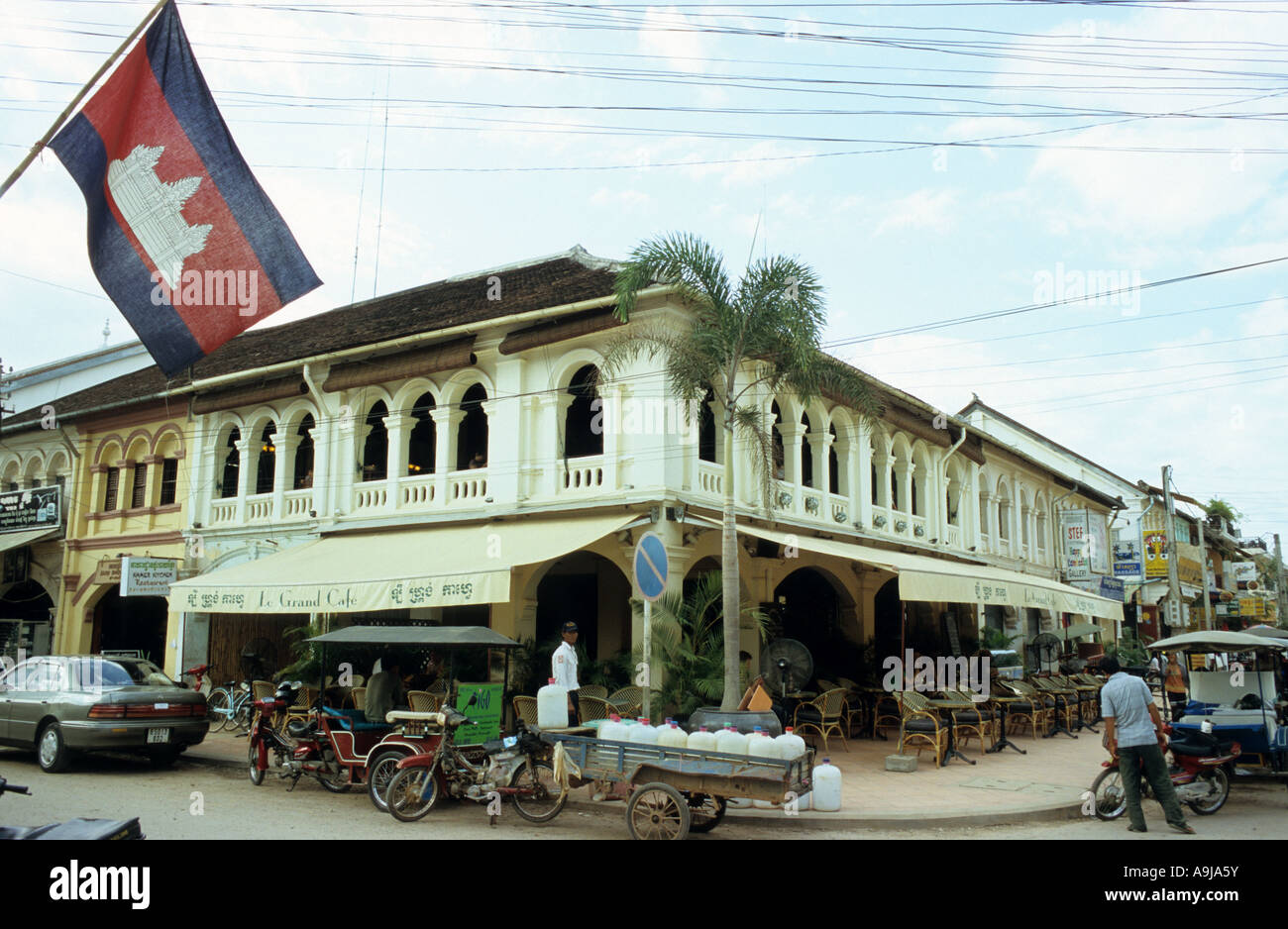 Le Grand Cafe in an old French colonial building, and Cambodian flag, Siem Reap, Cambodia Stock Photo