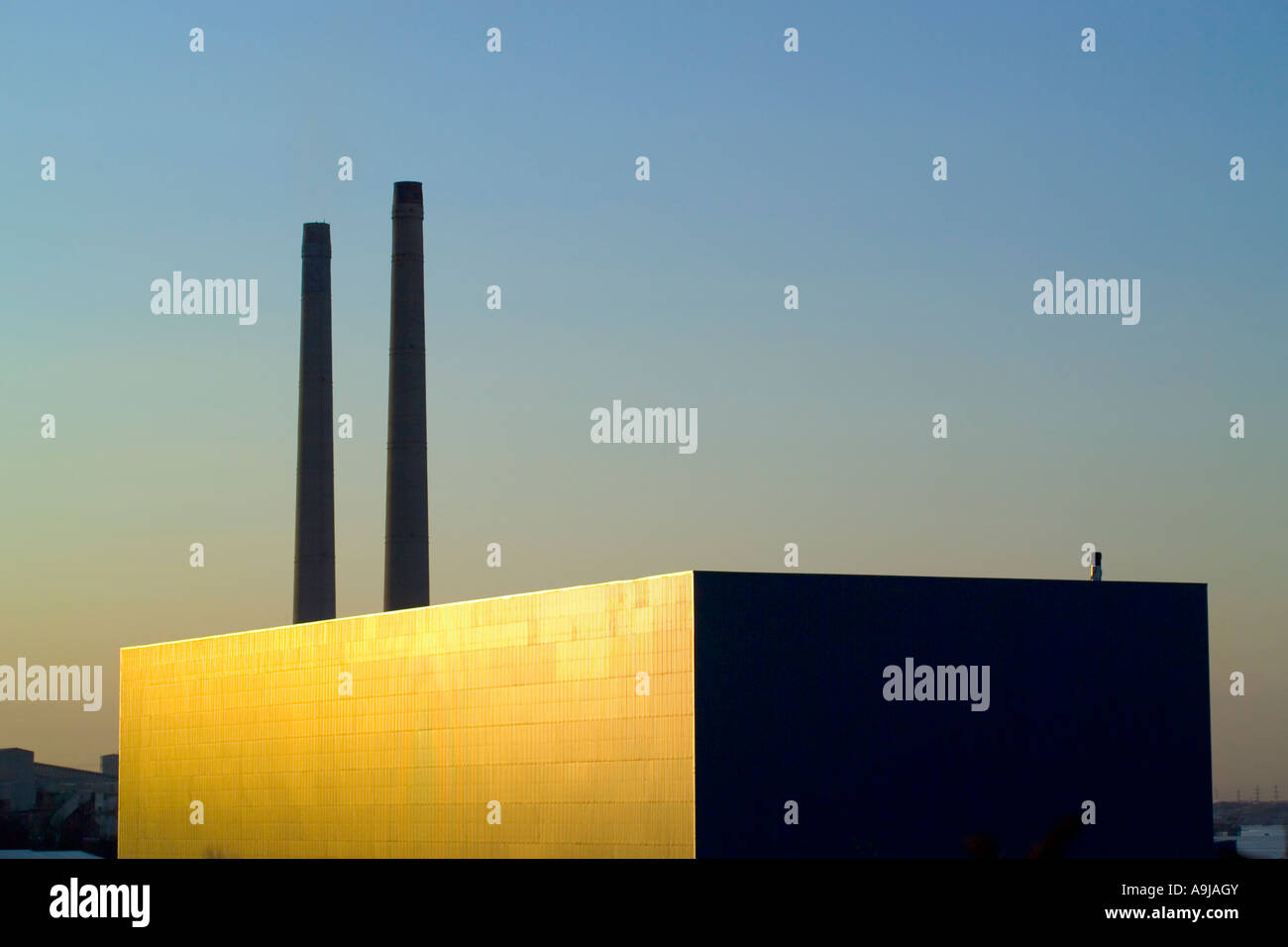 The Chimney's of the old Blue Circle cement works at Northfleet, Kent, at sunset with new warehouse in the foreground. Demolished in 2010 Stock Photo