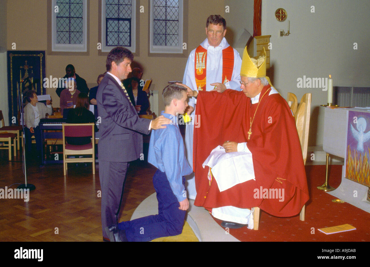 Confirmation At Pentecost Bishop Annointing Candidate at St Josephs Church Catholic London England Stock Photo