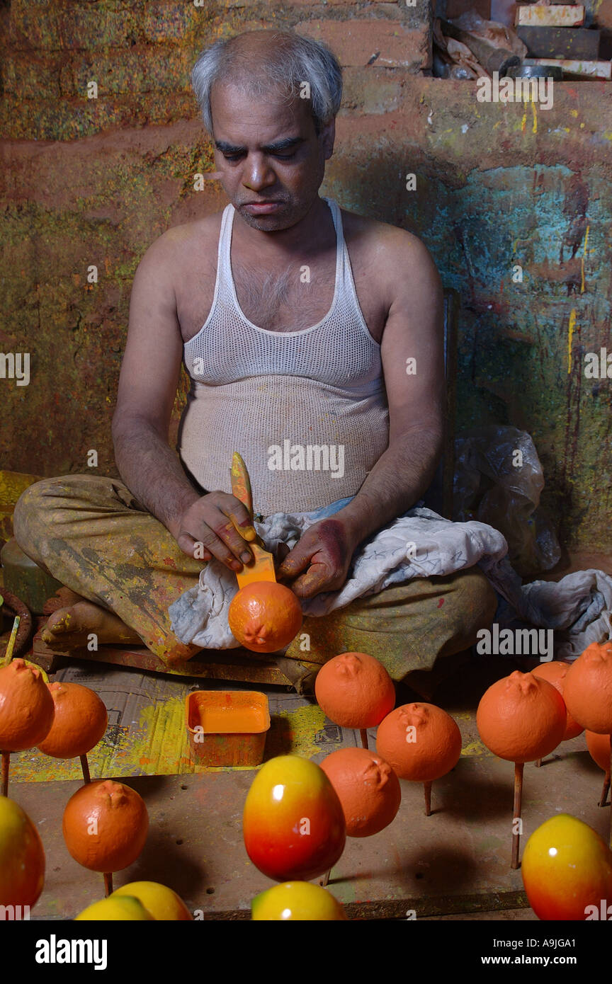 Man Painting Wooden Fruits educational toy Sawantwadi Maharashtra India Model Release No 595 Stock Photo