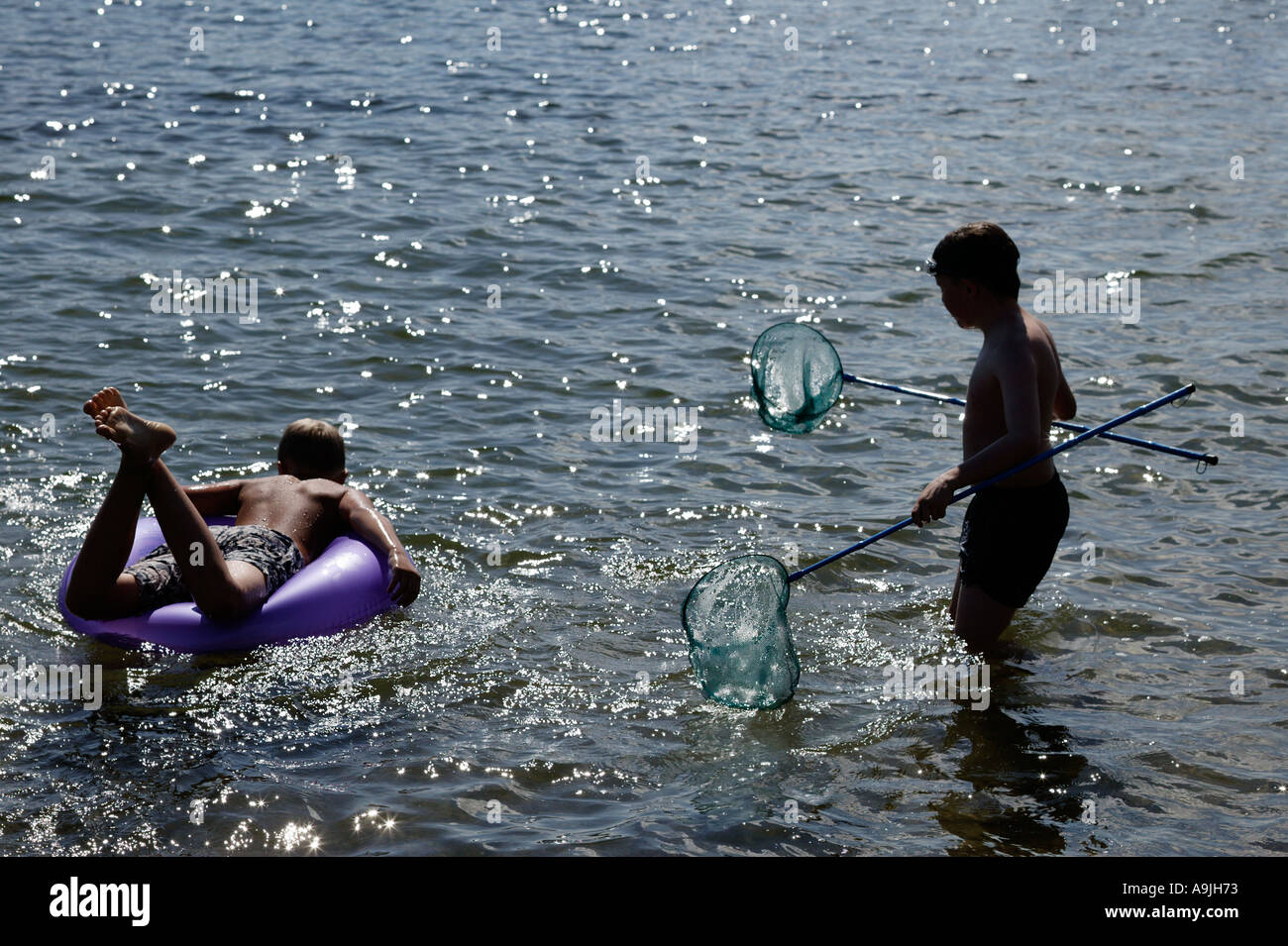 two boys swimming in the sea Stock Photo - Alamy