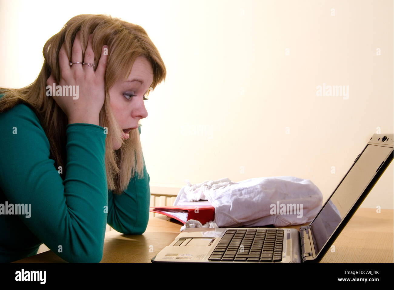 Young girl using laptop computer shocked by something she sees Stock ...