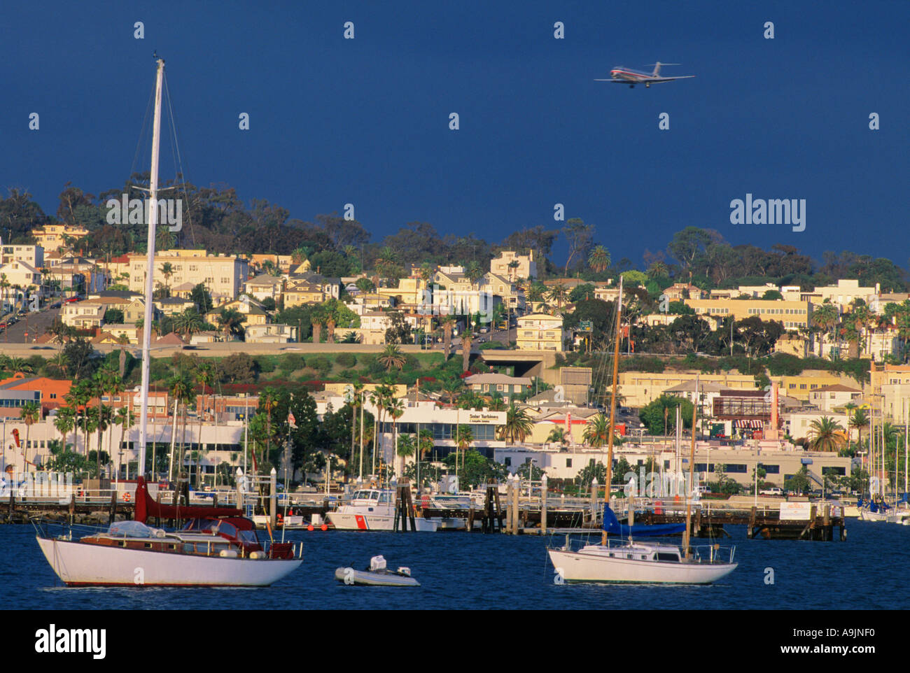 Airliner flying over residential area of San Diego Stock Photo