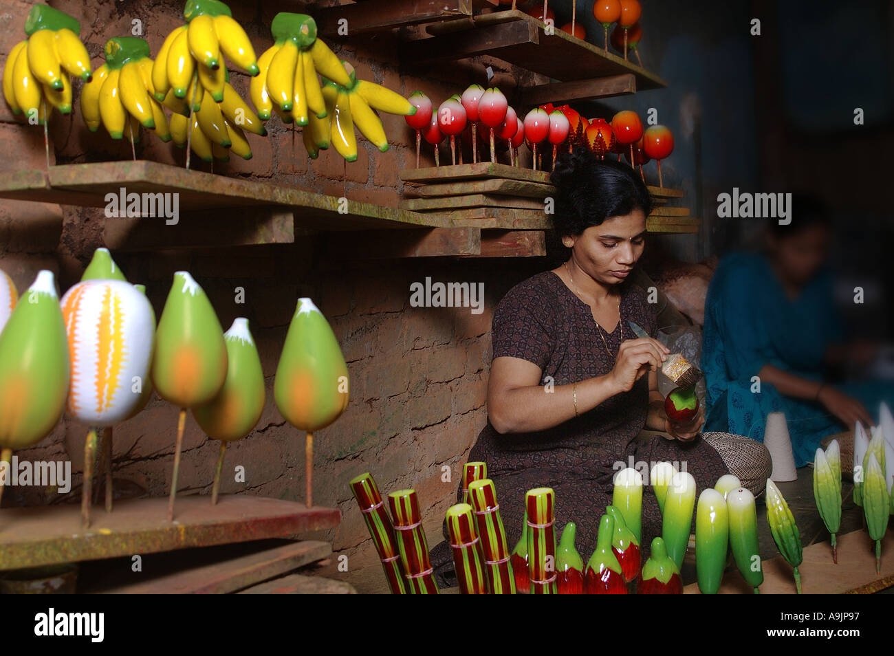 Artist painting wooden fruits Sawantwadi Maharashtra India Model Release 596 Stock Photo