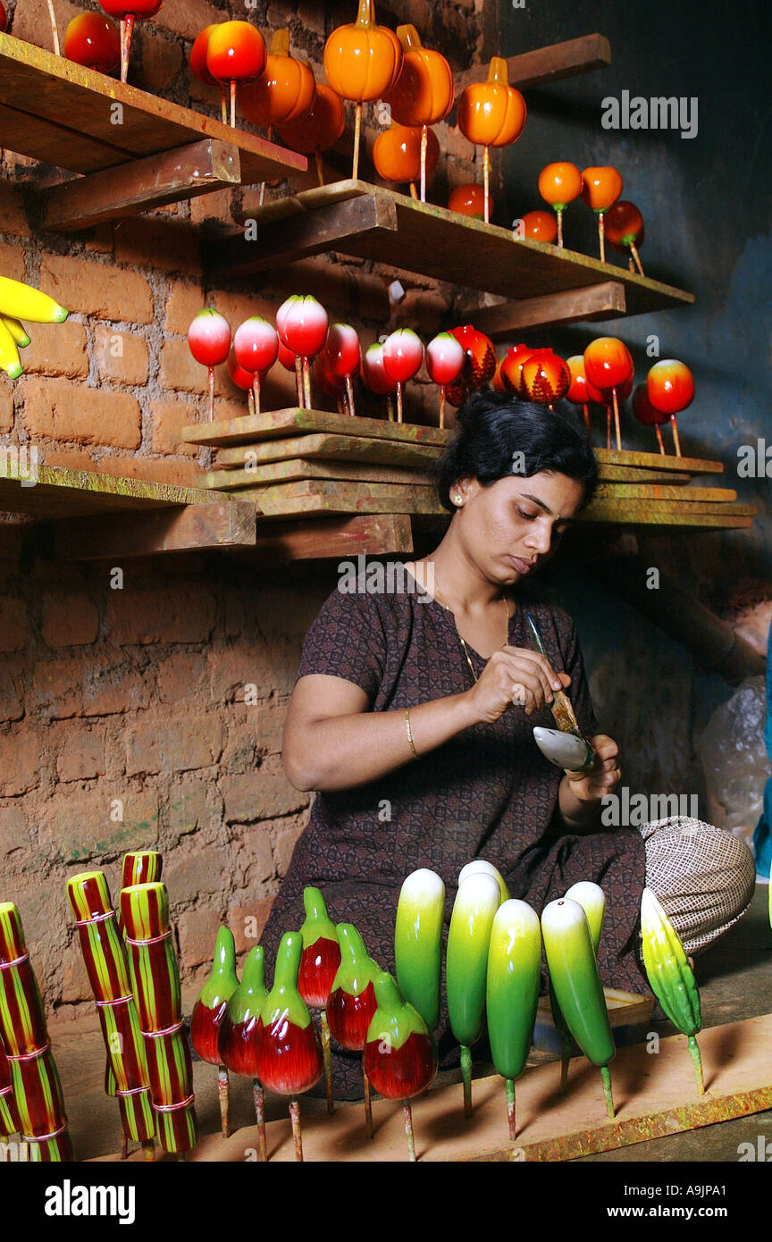 ANG99193 Artist painting wooden fruits Sawantwadi Maharashtra India Model Release 596 Stock Photo