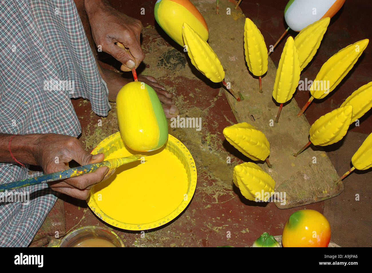 ANG99195 Artist Painting Wooden Fruits Sawantwadi Sindhudurga Maharashtra India Stock Photo