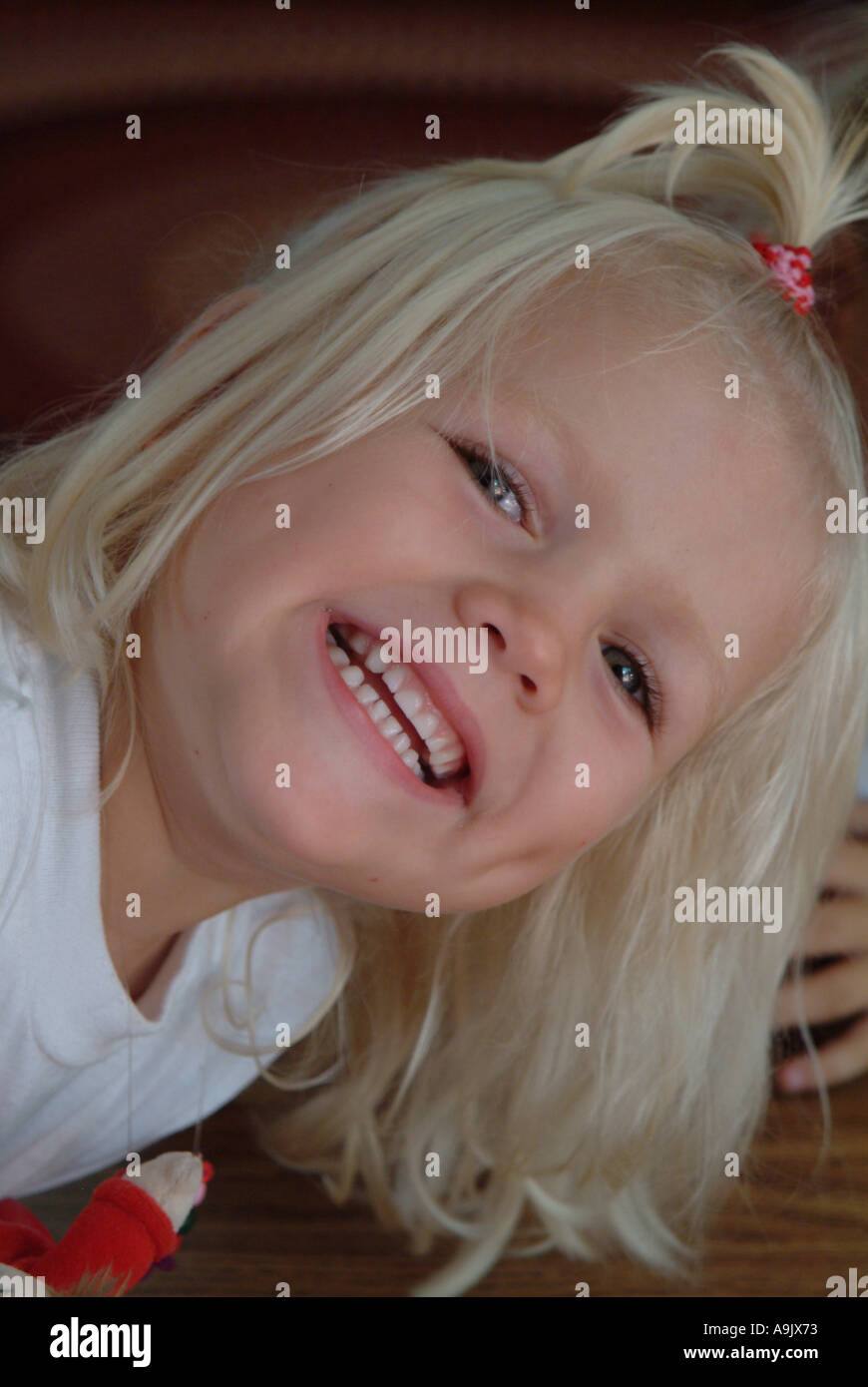 Portrait of a little blonde girl smiling Stock Photo - Alamy