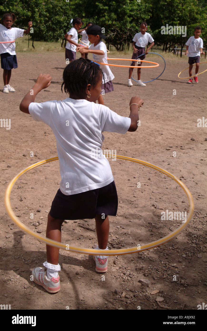 Children playing outside with plastic hula hoops Stock Photo