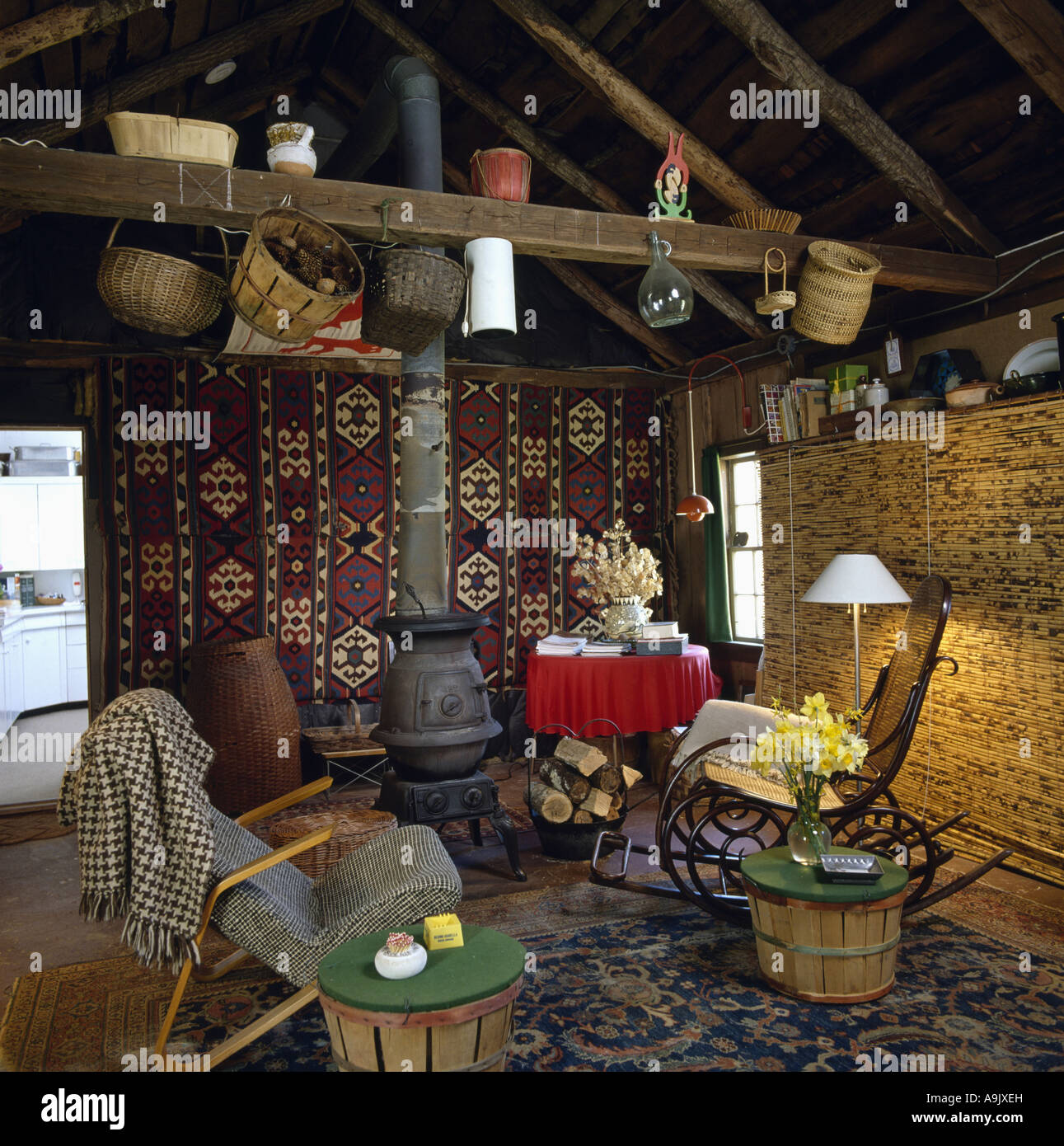Oriental Carpet On Wall Behind Castiron Stove In Log Cabin Sitting
