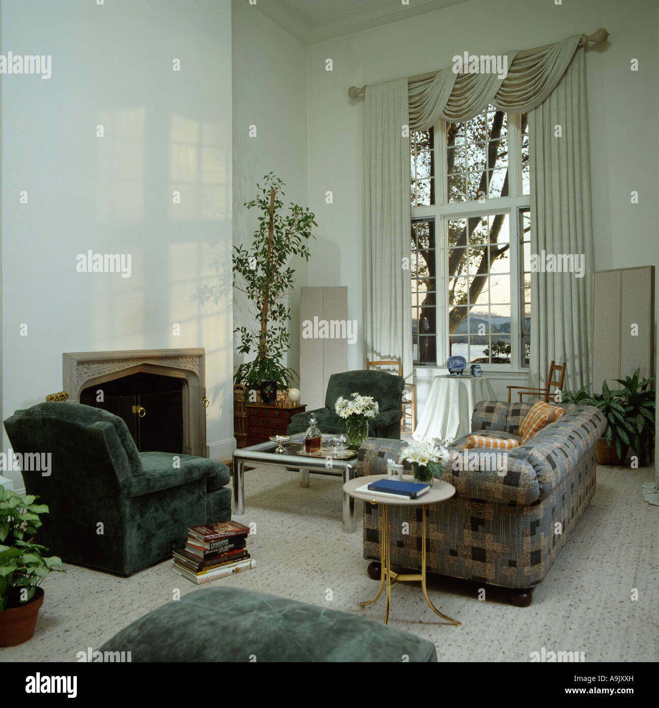 Green velour armchair and blue and grey plaid sofa in white eighties