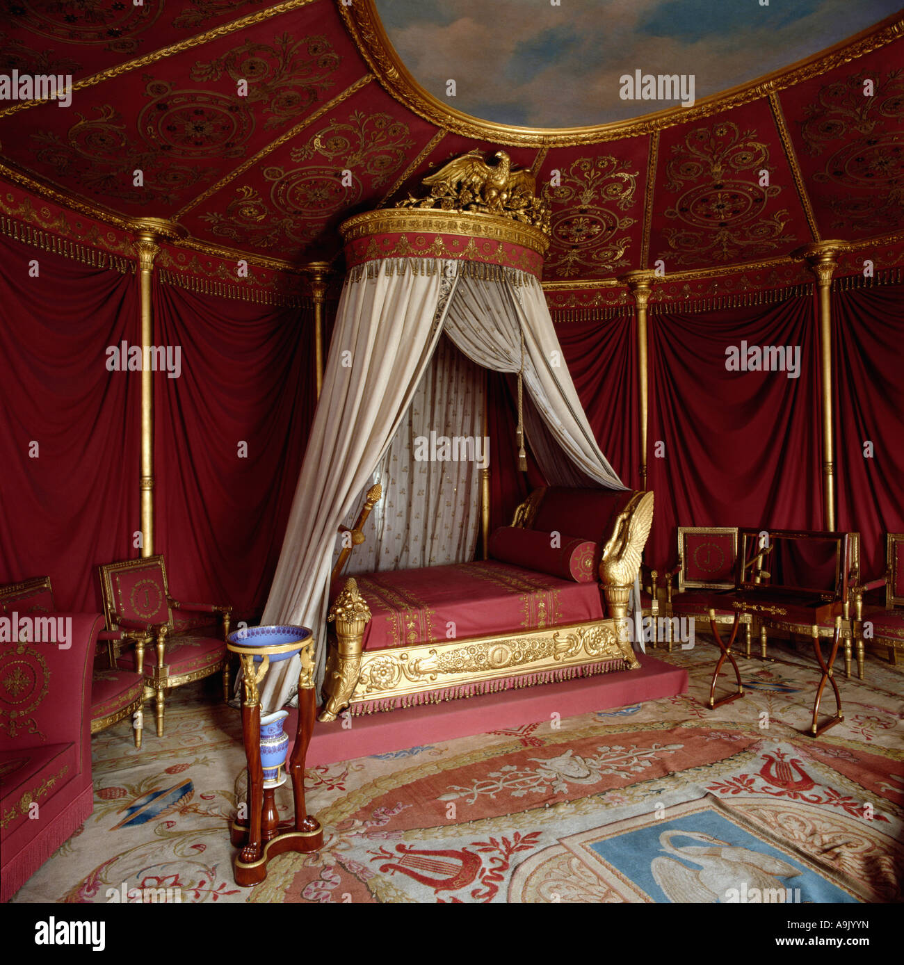 Ornate Gold Coronet With Cream Drapes On Baroque Gold Bed In