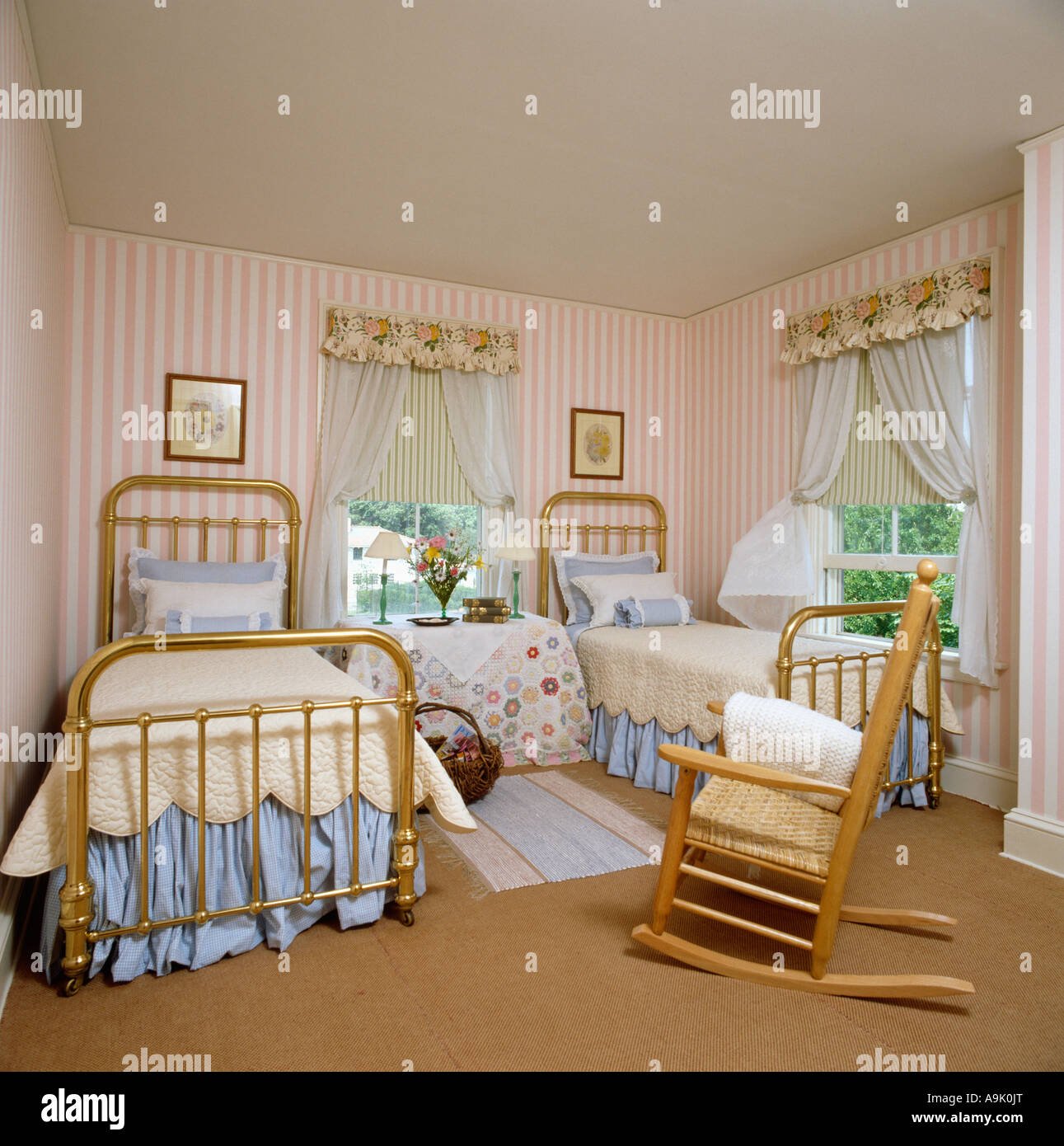 Rockingchair And Twin Beds With Brass Bedsteads In Bedroom