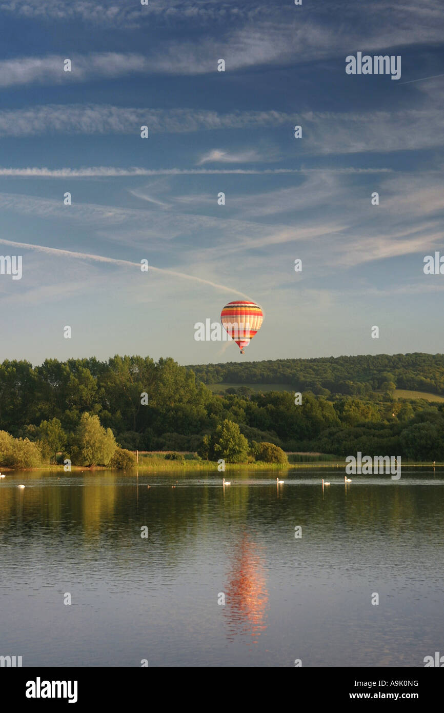 a balloon flying over a lake Stock Photo