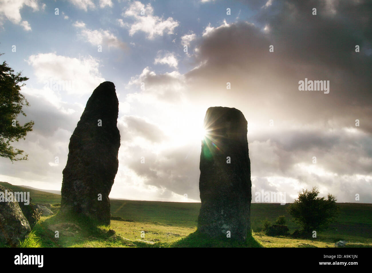 standing stones on Dartmoor with the sun behind Stock Photo