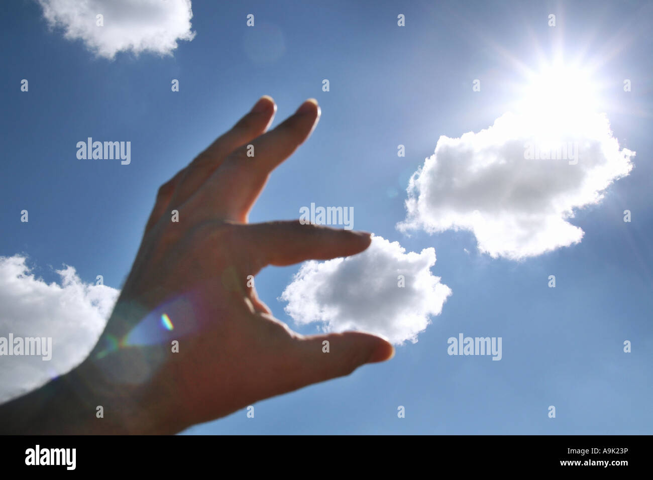 fingers holding a cloud Stock Photo