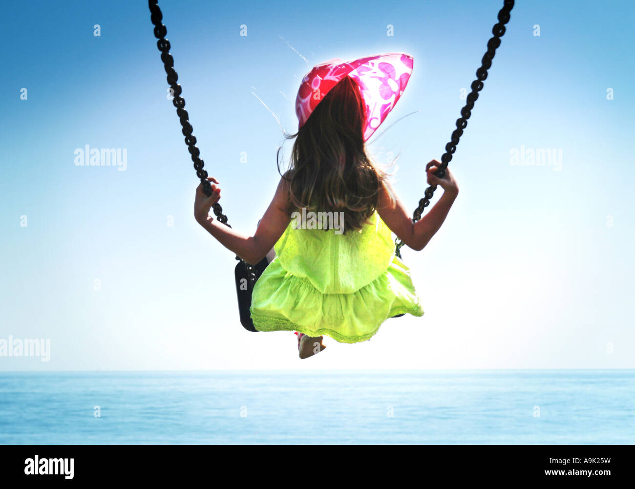 girl swinging over sea Stock Photo