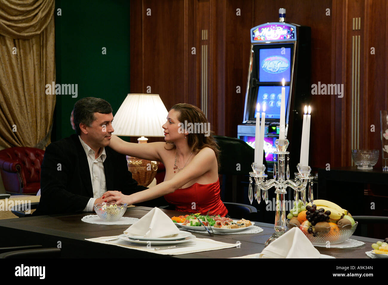 A young couple enjoying each others company in a bar in VIP casino Stock Photo