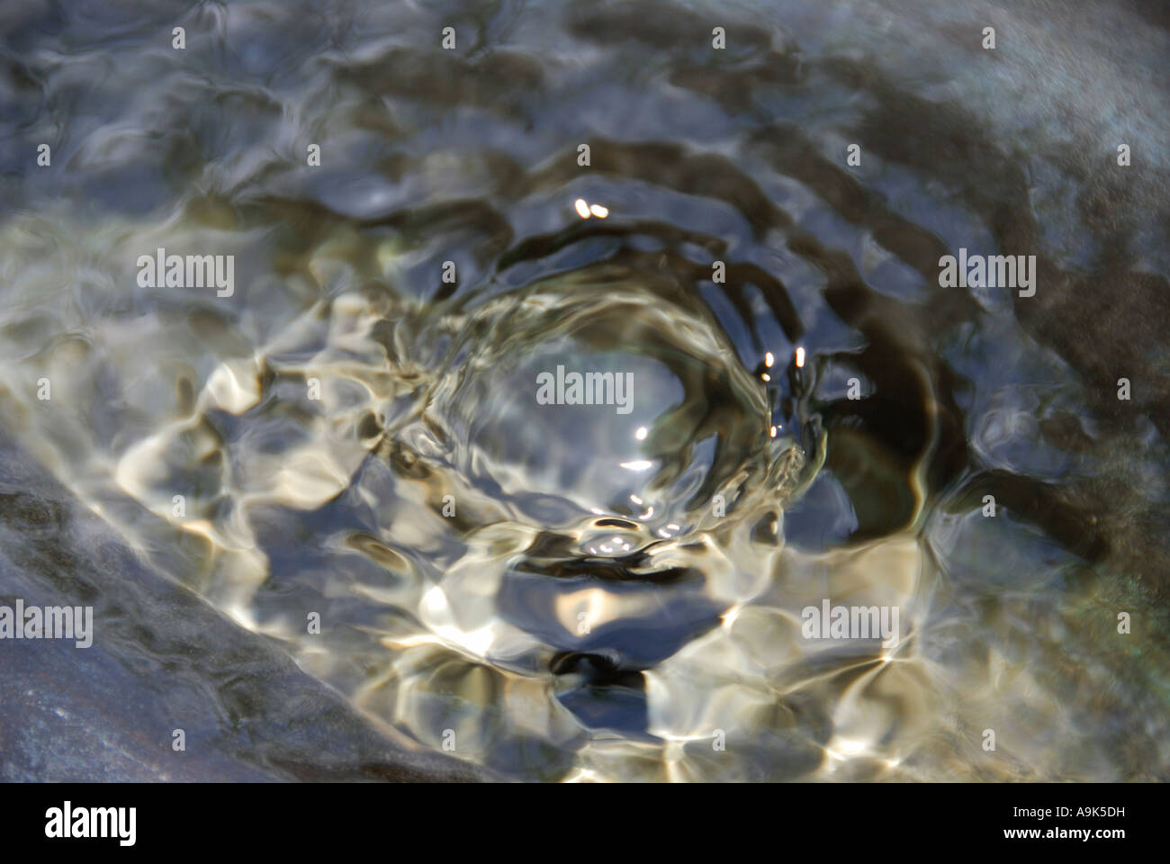 'Water 'welling up' from a spring in a stone fountain, California' Stock Photo