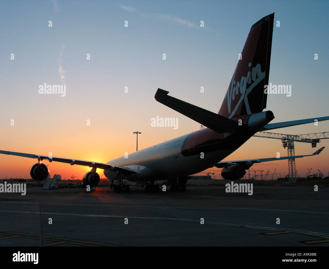 Virgin Atlantic Airbus at Heathrow Airport with terminal 5 cranes and