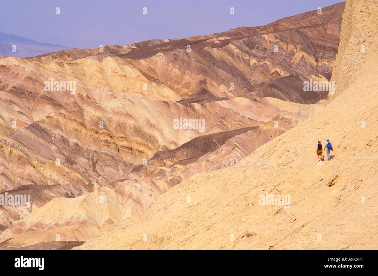 Sedimentary rock and hikers along the Zabriskie Point Trail Death