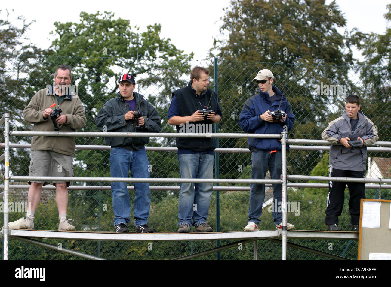 A group of model racing car enthusiasts race their remote control