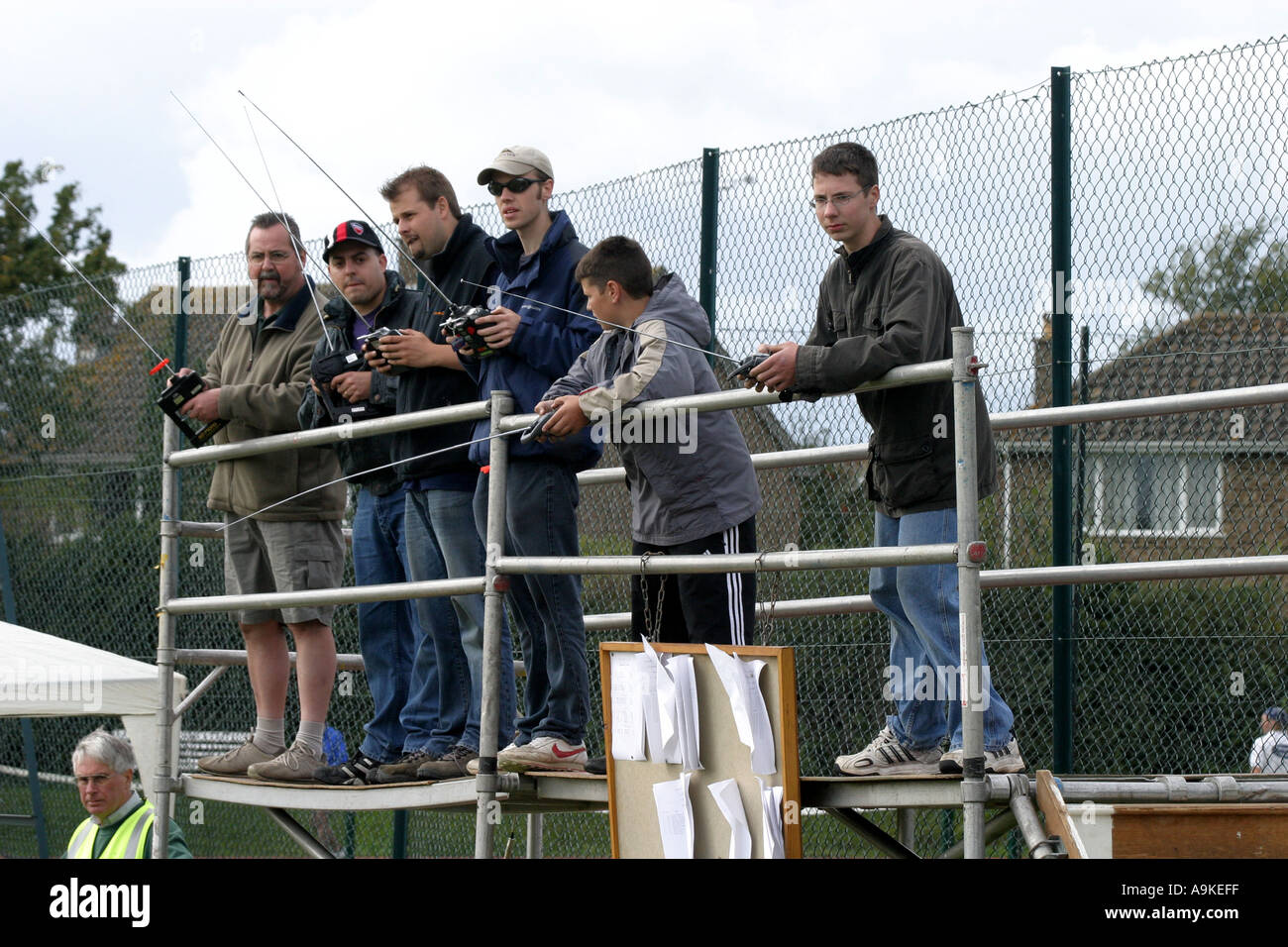 A group of model racing car enthusiasts race their remote control