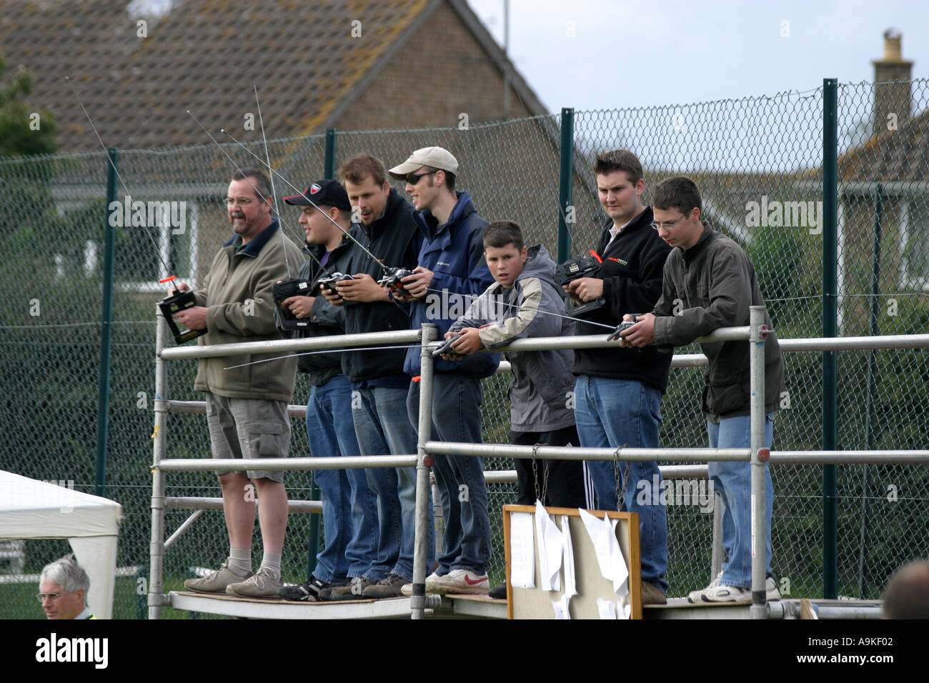 A group of model racing car enthusiasts race their remote control