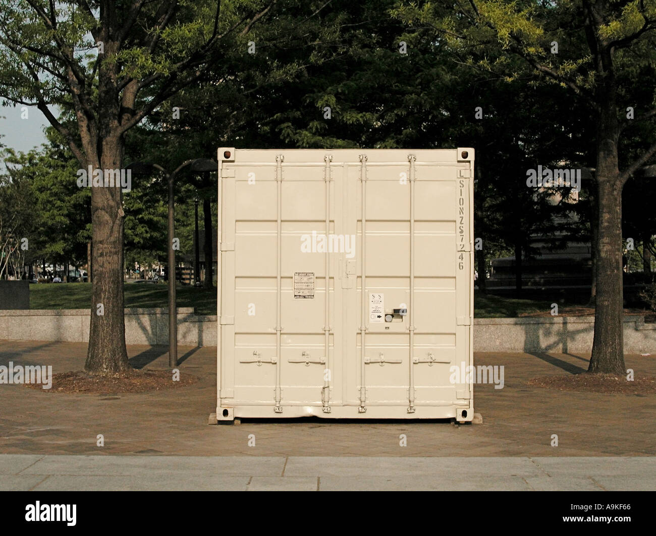 Industrial container on a paved street in front of park Stock Photo - Alamy
