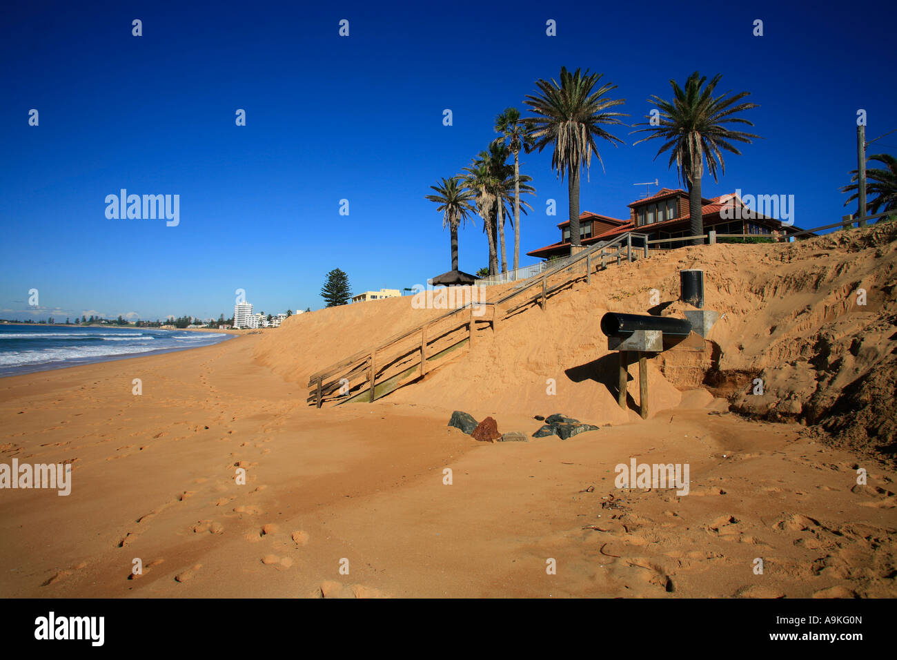 Global warming and climate change are made manifest in changing sand levels on this Australia surf beach Stock Photo