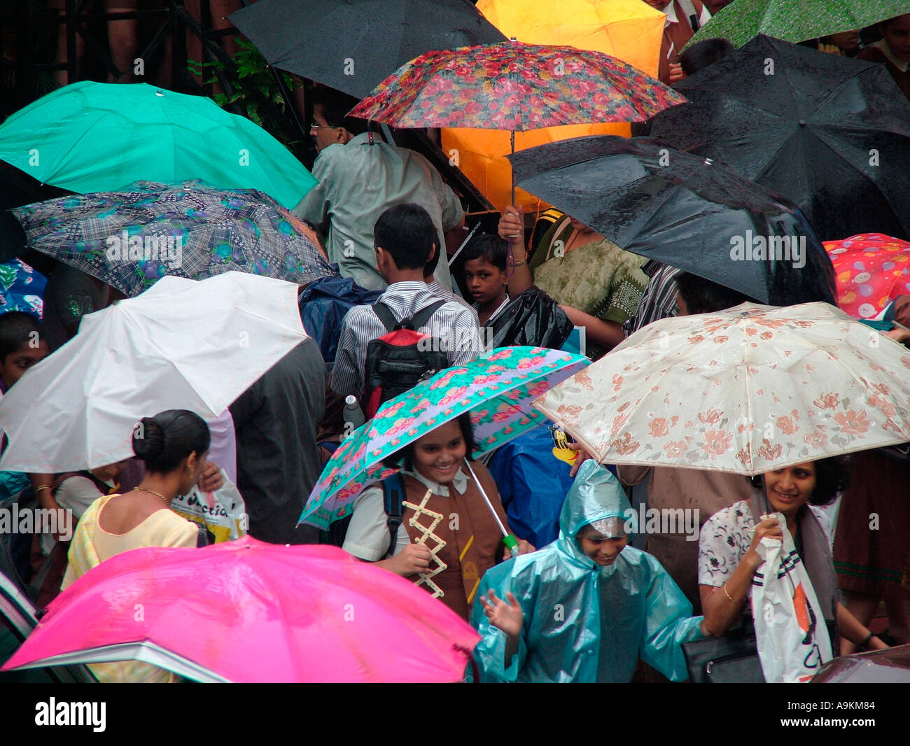 ANG98968 Rain colourful Umbrellas in school children and parents hand ...