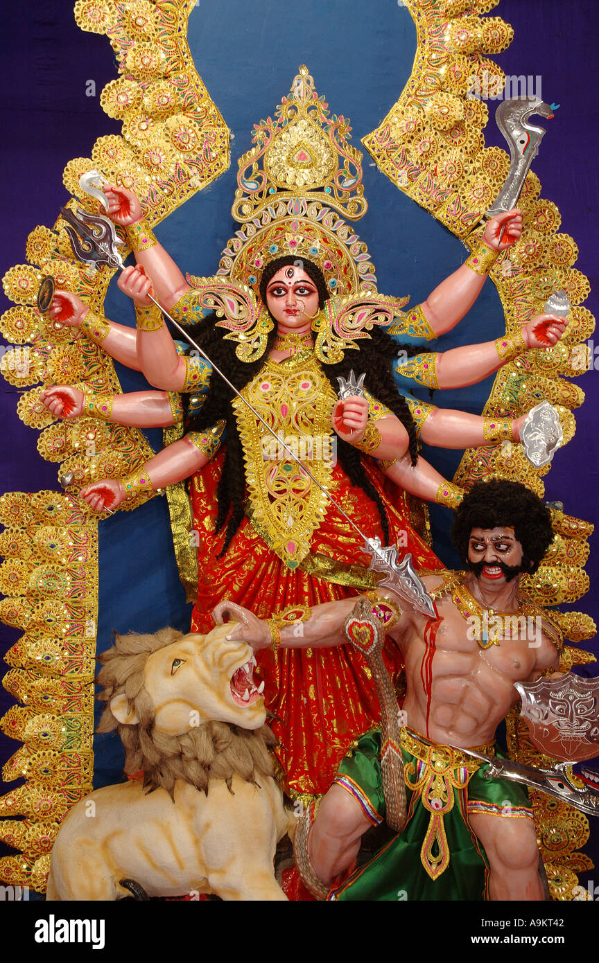 Indian Goddess Durga statue with ten hands slaying the demon in Stock
