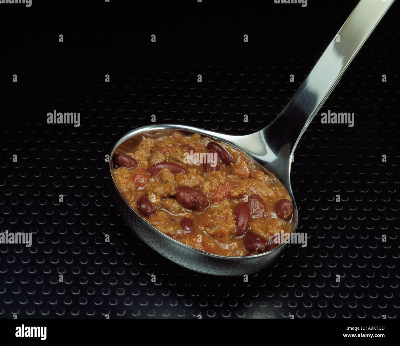 close up silver pweter ladle chili con carne copy space Bon Appetit