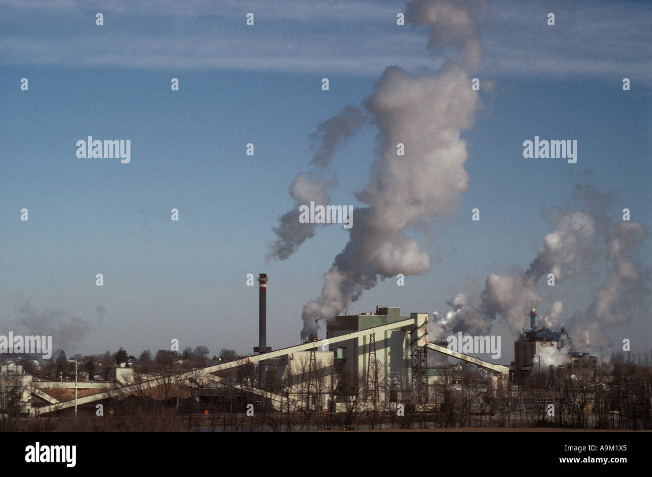 large factory billowing smoke stack smokestacks against blue sky cloud ...