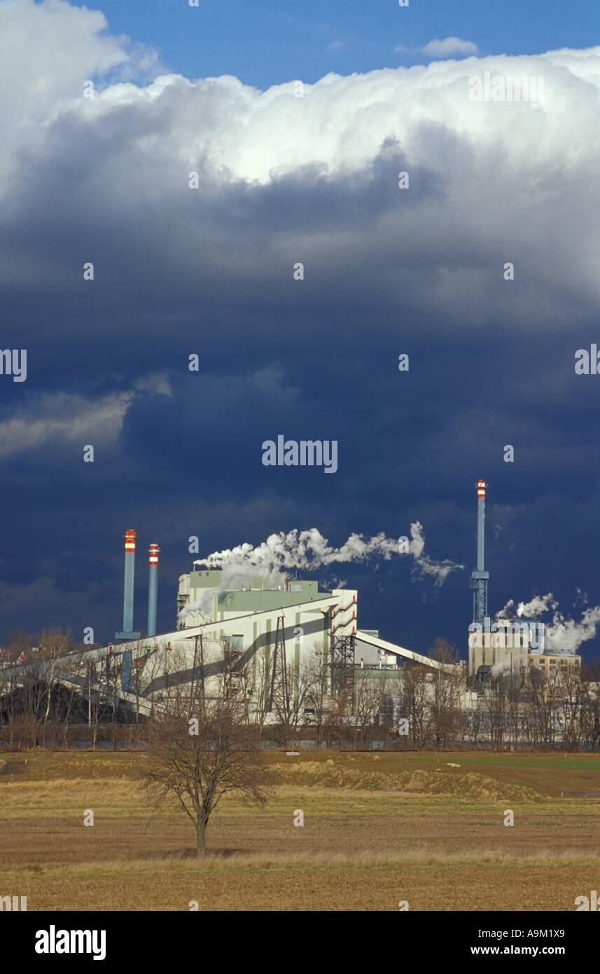 large factory billowing smoke stack smokestacks against blue sky cloud ...