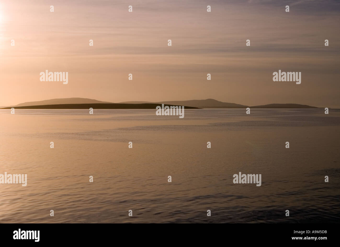 dh  ROUSAY ORKNEY Islands of Muckle Green Holm and hills of Rousay at dusk calm sea sky Stock Photo