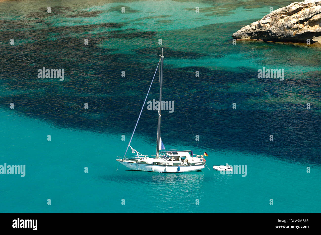 sailboat anchoring in Cala Galdana Stock Photo