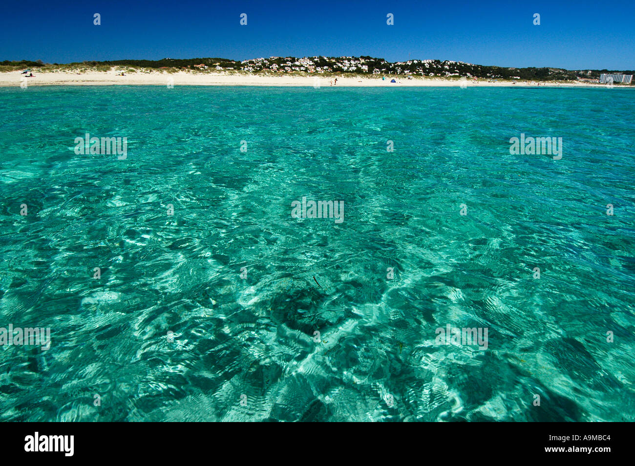 turquoise waters in front of the beach of Sant Tomas Stock Photo