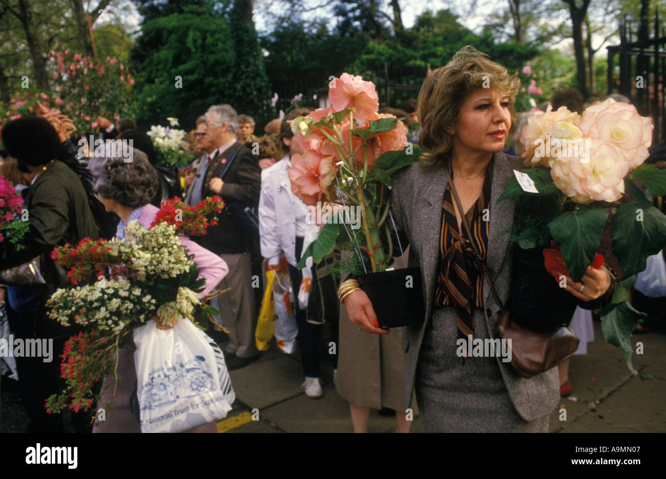 Last day of the Chelsea Flower show 1990s London UK. Visitor to the flower show taking home some of the displayed flowers HOMER SYKES Stock Photo