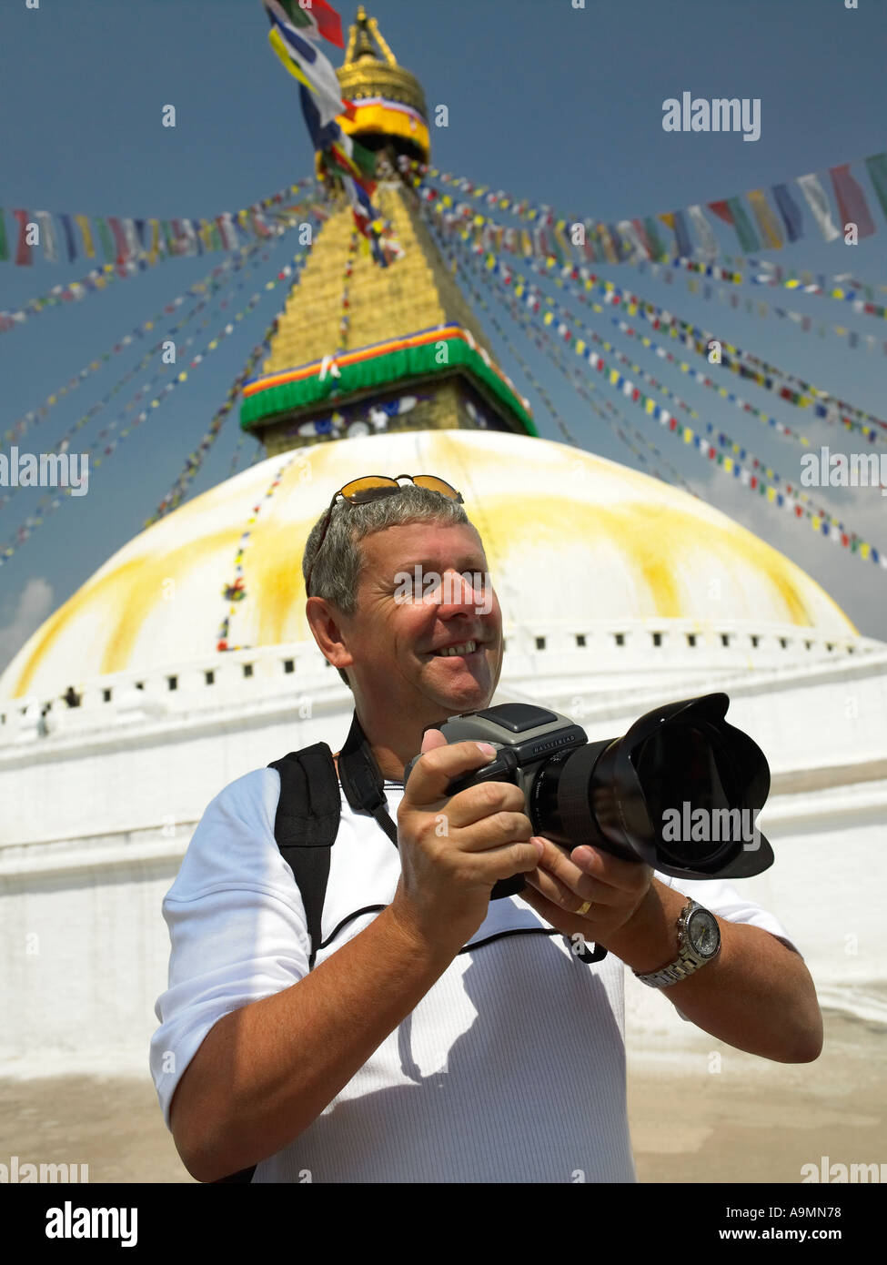 Photographer on location at Boudhanath Stupa in Kathmandu in Nepal Stock Photo