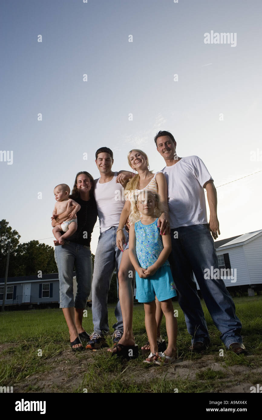 Portrait of two bluecollar families standing in front of trailer homes Stock Photo Alamy