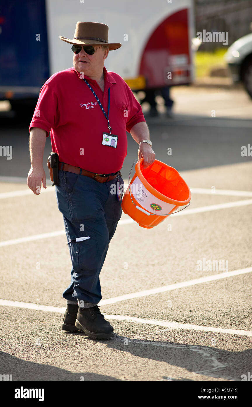 charity collector with bucket looking for donations Stock Photo - Alamy