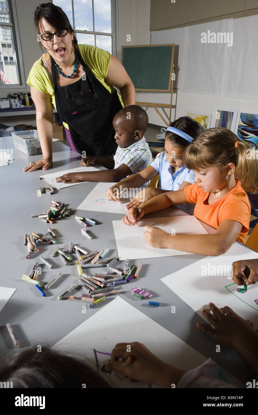 An art teacher teaching young students in art class Stock Photo Alamy
